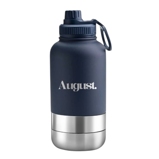 A navy blue water bottle with a silver bottom and a branded label that reads 'August'.